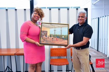 April Ellerbe accepting the painting for the Durham CVB